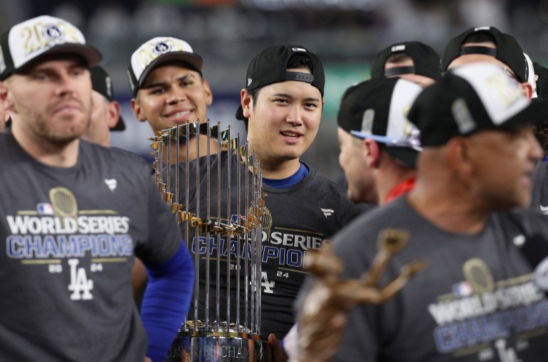 NEW YORK, NEW YORK - OCTOBER 30: Shohei Ohtani #17 of the Los Angeles Dodgers celebrates with the trophy after the Dodgers defeated the New York Yankees 7-6 in Game 5 to win the 2024 World Series at Yankee Stadium on October 30, 2024 in the Bronx borough of New York. Elsa/Getty Images/AFP (Photo by ELSA / GETTY IMAGES NORTH AMERICA / Getty Images via AFP)